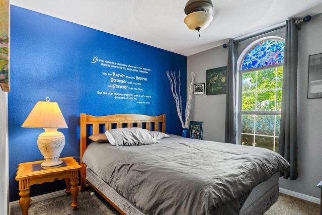 bedroom featuring carpet and baseboards