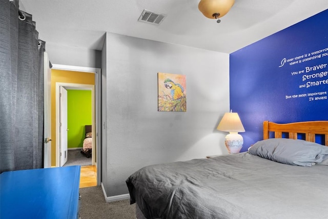 bedroom featuring visible vents, carpet flooring, and baseboards