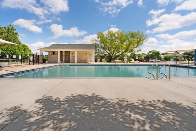 community pool featuring a patio and fence