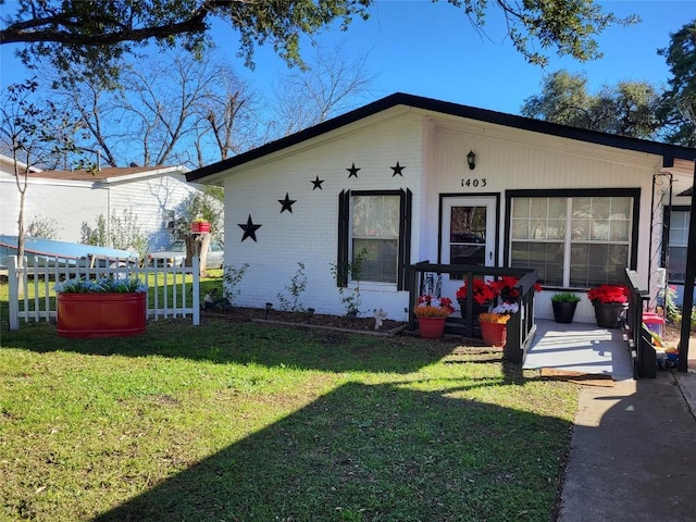 1403 Wallace St, Taylor, TX 76574 - view of front of home featuring covered porch, brick siding, and a front lawn