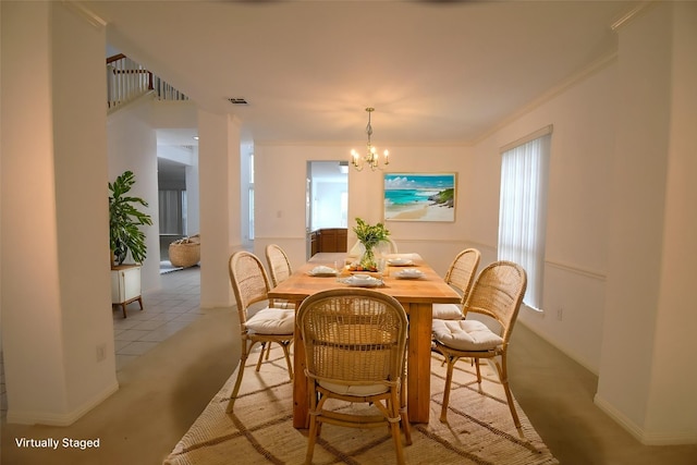 dining area with crown molding, visible vents, baseboards, light carpet, and a notable chandelier