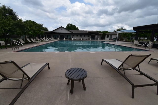 pool with fence and a patio
