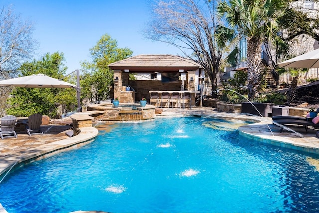 pool with a patio, a gazebo, an in ground hot tub, and outdoor dry bar