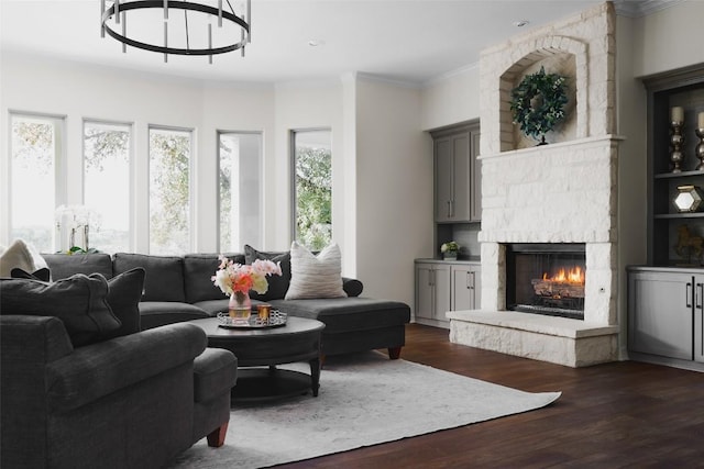 living area featuring a fireplace, crown molding, and dark wood finished floors