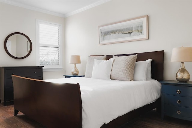 bedroom with crown molding and dark wood finished floors