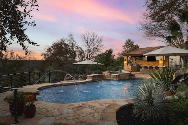 view of pool featuring outdoor dry bar, fence, a fenced in pool, and a patio area