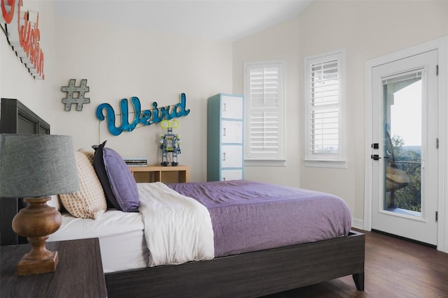 bedroom with lofted ceiling, wood finished floors, access to outside, and baseboards