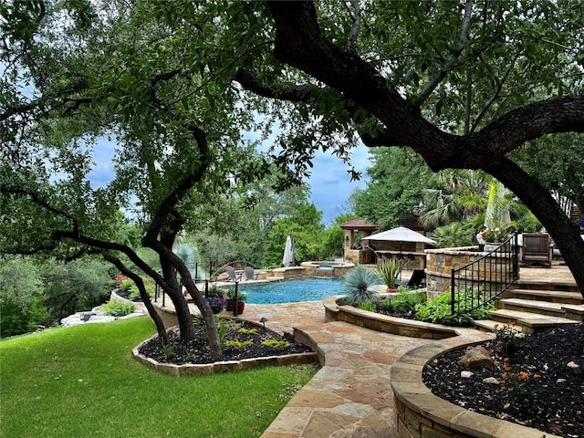 view of pool with a lawn, a deck, and a pool with connected hot tub