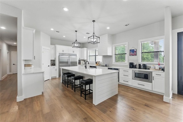 725 Winding Vw, New Braunfels, TX 78132 - kitchen with a sink, decorative backsplash, built in appliances, visible vents, and light countertops