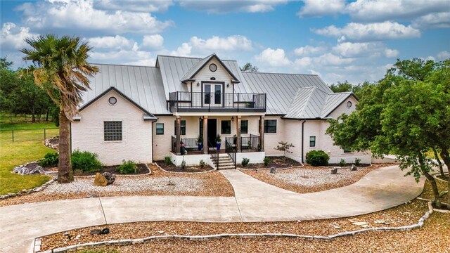 725 Winding Vw, New Braunfels, TX 78132 - modern farmhouse style home featuring covered porch, metal roof, a balcony, and a standing seam roof