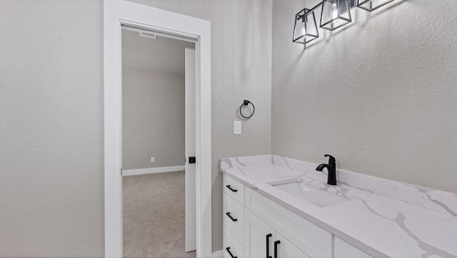 725 Winding Vw, New Braunfels, TX 78132 - bathroom with baseboards, visible vents, and vanity