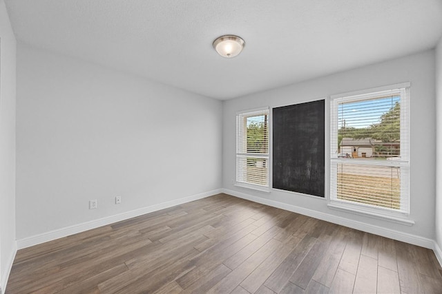 12808 Silver Creek Dr, Austin, TX 78727 - spare room featuring baseboards and wood finished floors