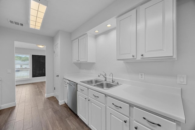 12808 Silver Creek Dr, Austin, TX 78727 - kitchen featuring stainless steel dishwasher, dark wood-style flooring, white cabinets, light countertops, and recessed lighting