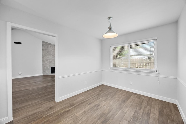 12808 Silver Creek Dr, Austin, TX 78727 - empty room with wood finished floors and a large fireplace