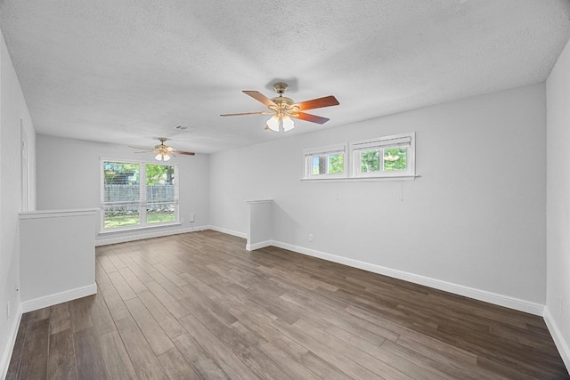 12808 Silver Creek Dr, Austin, TX 78727 - unfurnished room with healthy amount of natural light, wood finished floors, a textured ceiling, and ceiling fan