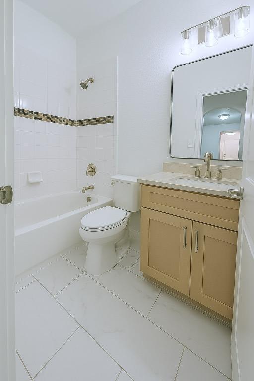 313 El Socorro Ln, Austin, TX 78732 - bathroom with vanity, tile patterned floors, tub / shower combination, and toilet