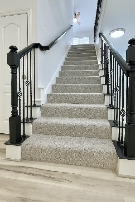 313 El Socorro Ln, Austin, TX 78732 - stairway featuring wood finished floors