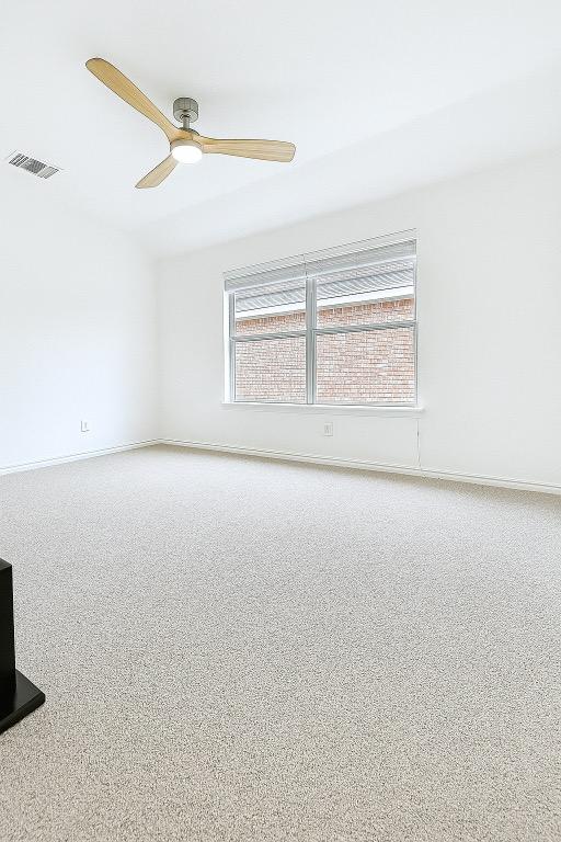 313 El Socorro Ln, Austin, TX 78732 - carpeted spare room featuring baseboards, ceiling fan, and visible vents