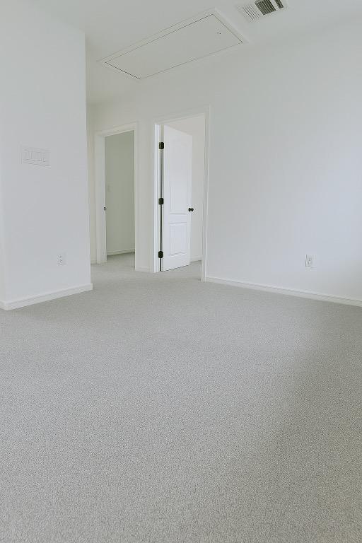 313 El Socorro Ln, Austin, TX 78732 - unfurnished room featuring attic access and light colored carpet