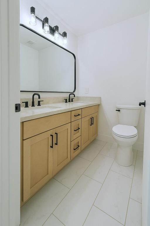 313 El Socorro Ln, Austin, TX 78732 - bathroom featuring double vanity and toilet