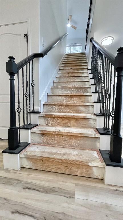 313 El Socorro Ln, Austin, TX 78732 - staircase featuring wood finished floors