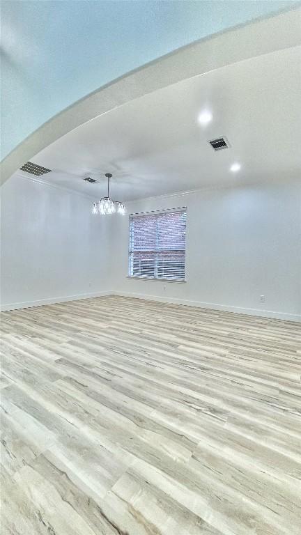 313 El Socorro Ln, Austin, TX 78732 - empty room with light wood-style flooring, a chandelier, and recessed lighting