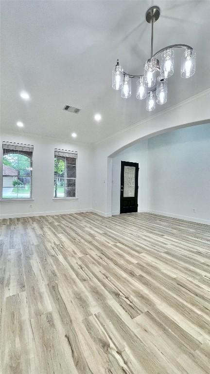 313 El Socorro Ln, Austin, TX 78732 - unfurnished living room with recessed lighting, baseboards, visible vents, and wood finished floors