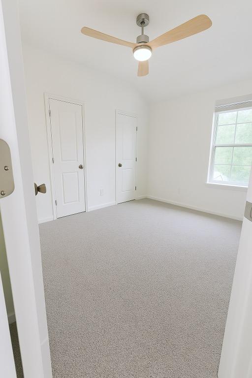 313 El Socorro Ln, Austin, TX 78732 - carpeted spare room with baseboards and ceiling fan