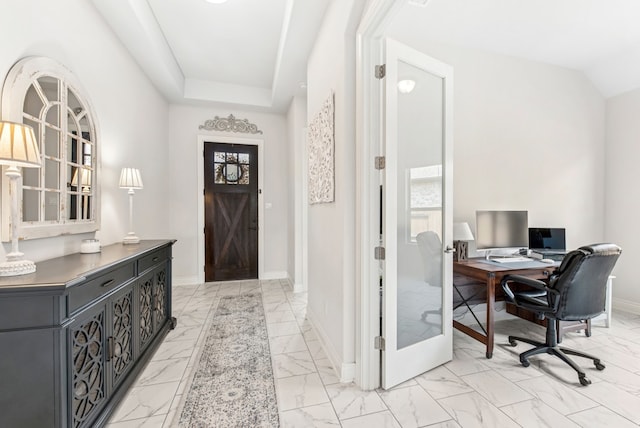 interior space featuring baseboards and marble finish floor