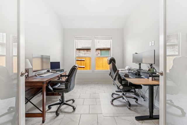 office area with marble finish floor and lofted ceiling