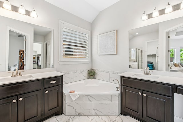 bathroom featuring a stall shower, marble finish floor, a sink, and lofted ceiling
