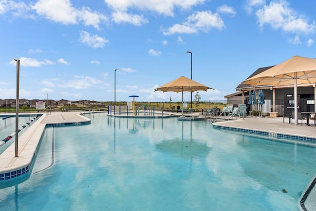 pool with a patio area and fence