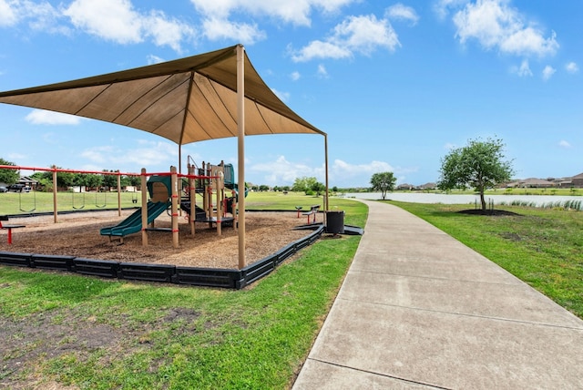 community playground with a water view and a yard