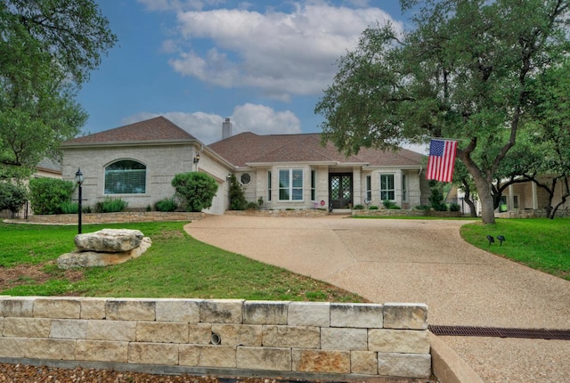 view of front of property with a front lawn, driveway, an attached garage, and a chimney