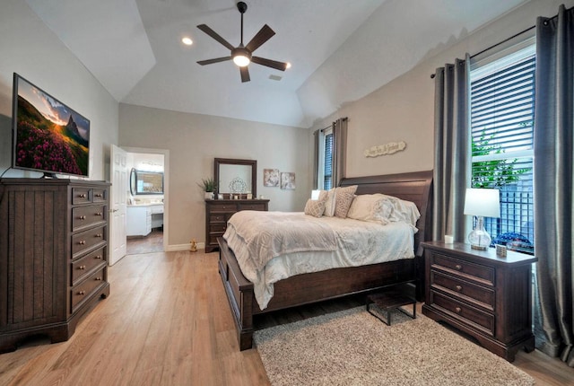 bedroom featuring ceiling fan, light wood-style floors, multiple windows, and vaulted ceiling
