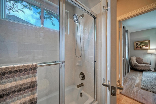 bathroom with shower / bath combination with glass door