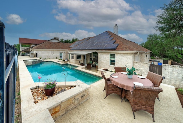 view of swimming pool with a fenced backyard, a patio area, a pool with connected hot tub, and outdoor dining area