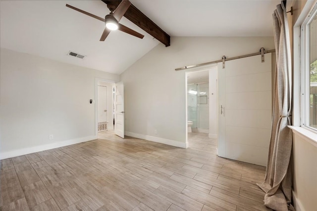 7310 Broken Arrow Ln, Austin, TX 78745 - unfurnished bedroom featuring lofted ceiling with beams, a barn door, light wood-style floors, ensuite bathroom, and visible vents