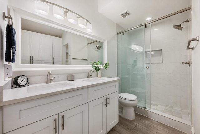 7310 Broken Arrow Ln, Austin, TX 78745 - full bath featuring a shower stall, double vanity, and a sink