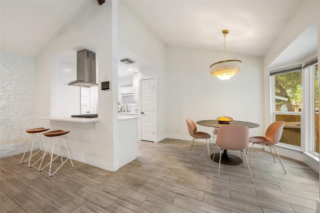 7310 Broken Arrow Ln, Austin, TX 78745 - dining room featuring visible vents, wood tiled floor, and vaulted ceiling