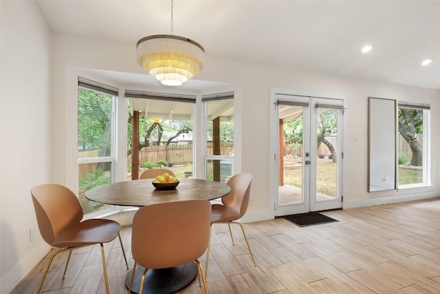 7310 Broken Arrow Ln, Austin, TX 78745 - dining room featuring baseboards, a notable chandelier, a healthy amount of sunlight, and french doors