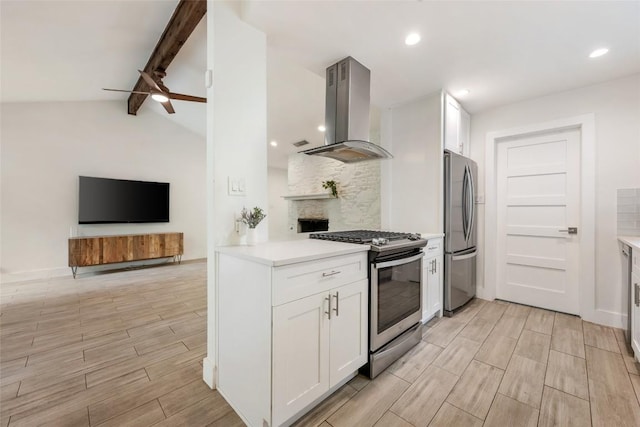 7310 Broken Arrow Ln, Austin, TX 78745 - kitchen featuring wood tiled floor, island exhaust hood, appliances with stainless steel finishes, and open floor plan