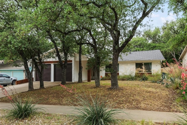7310 Broken Arrow Ln, Austin, TX 78745 - ranch-style house with a shingled roof and concrete driveway
