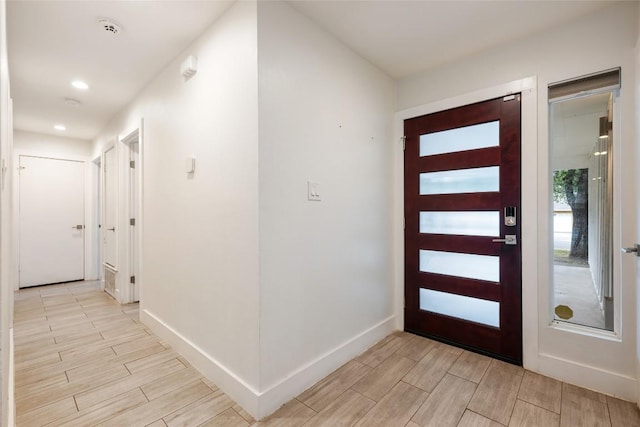 7310 Broken Arrow Ln, Austin, TX 78745 - foyer with wood tiled floor, recessed lighting, and baseboards