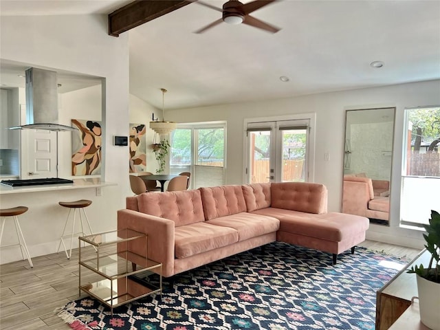 7310 Broken Arrow Ln, Austin, TX 78745 - living room with lofted ceiling with beams, a ceiling fan, wood finished floors, and plenty of natural light