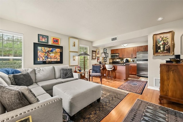 7685 Northcross Dr Unit 304, Austin, TX 78757 - living area with light wood-style flooring and a textured ceiling