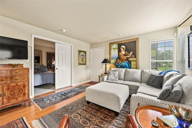 7685 Northcross Dr Unit 304, Austin, TX 78757 - living area featuring wood finished floors and baseboards