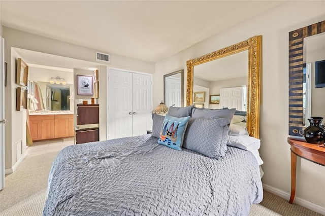 7685 Northcross Dr Unit 304, Austin, TX 78757 - bedroom featuring light colored carpet, ensuite bath, and a closet