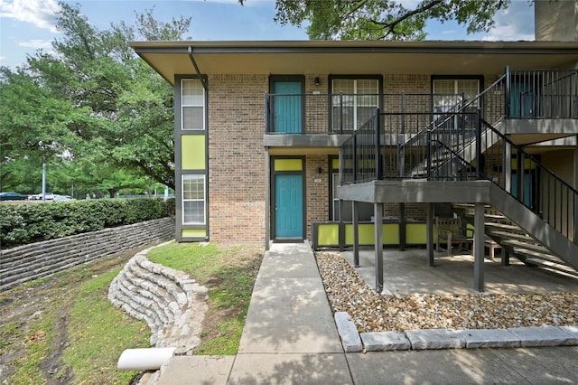 7685 Northcross Dr Unit 304, Austin, TX 78757 - view of front of property featuring brick siding and stairs
