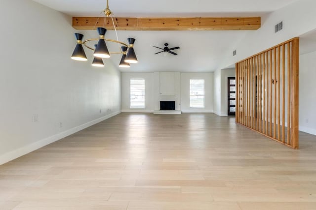 7901 Keswick Dr, Austin, TX 78745 - unfurnished living room with a chandelier, a brick fireplace, and light wood-style flooring